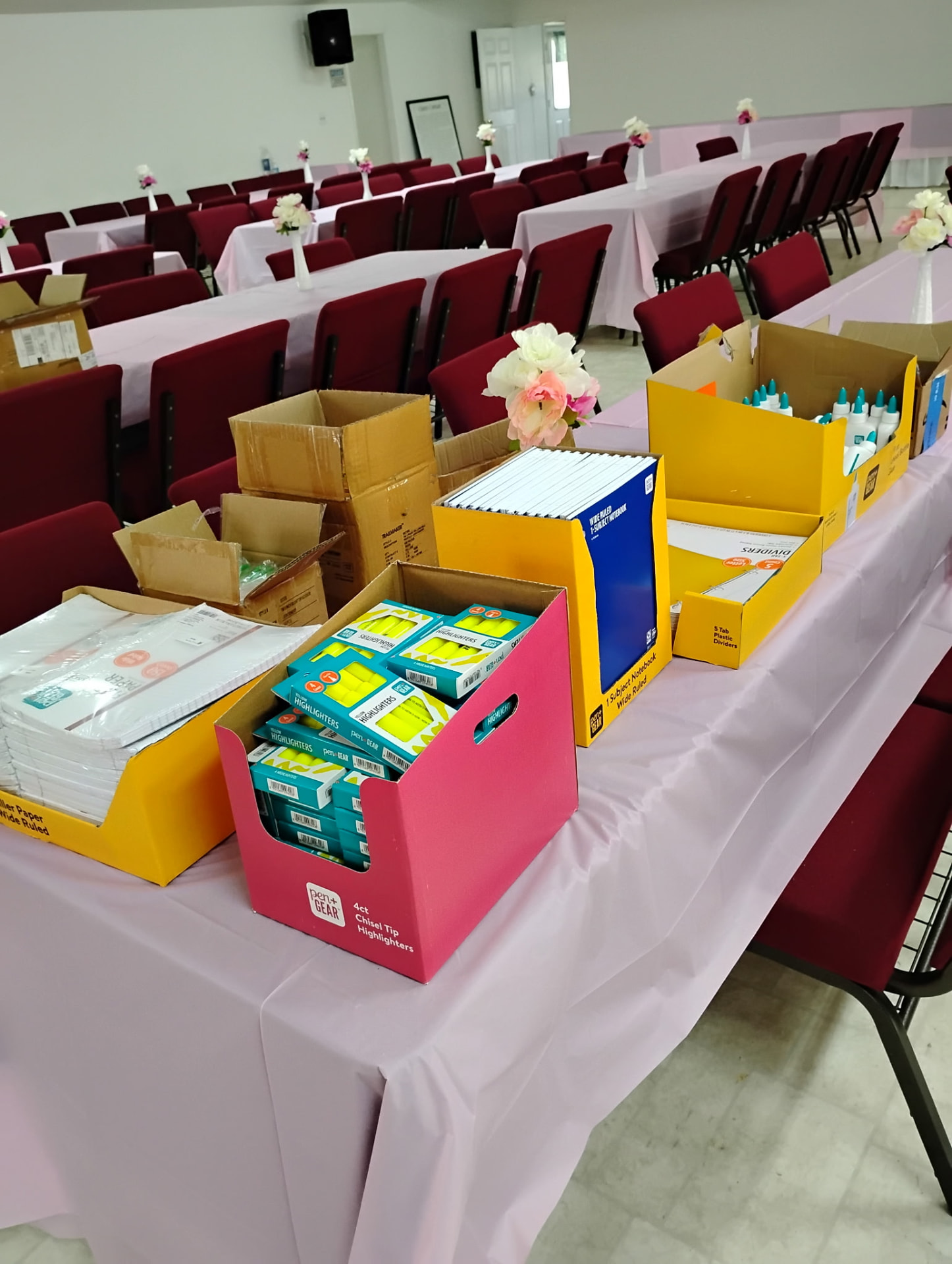 School supplies set out on tables in the fellowship hall