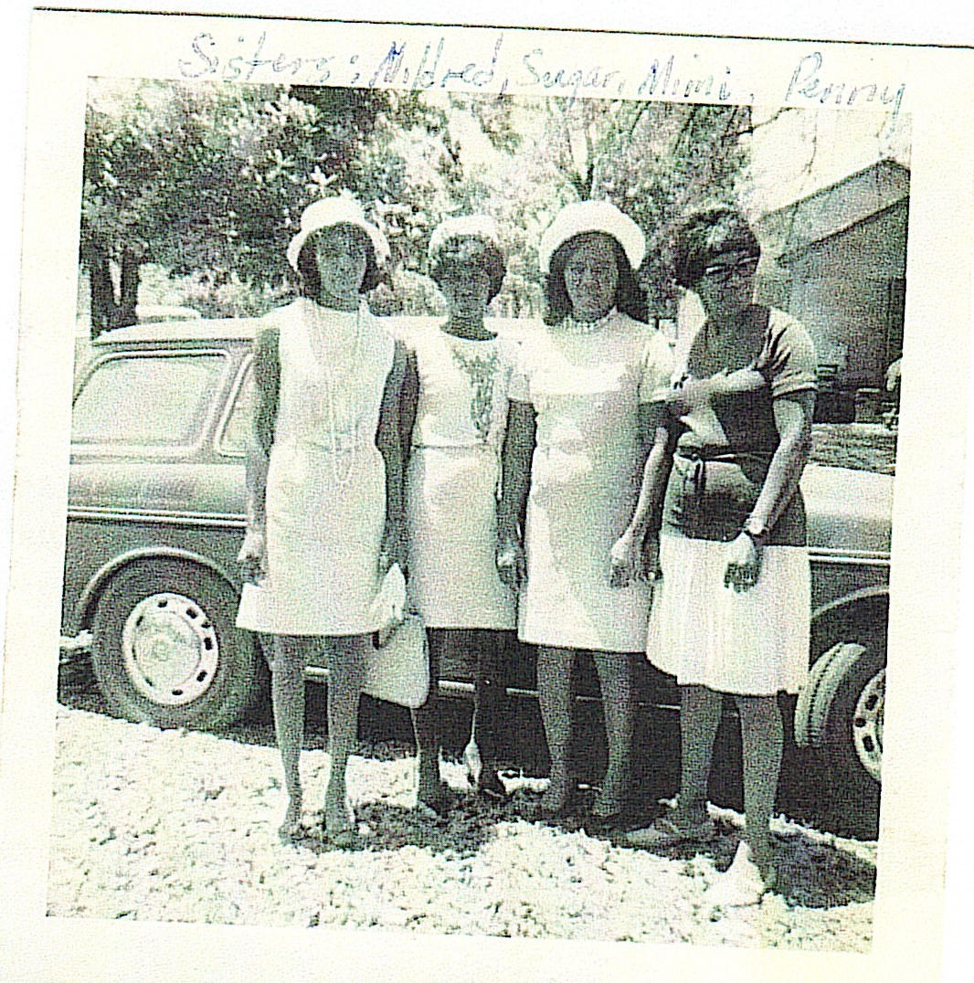 Historical family photograph of women in white dresses