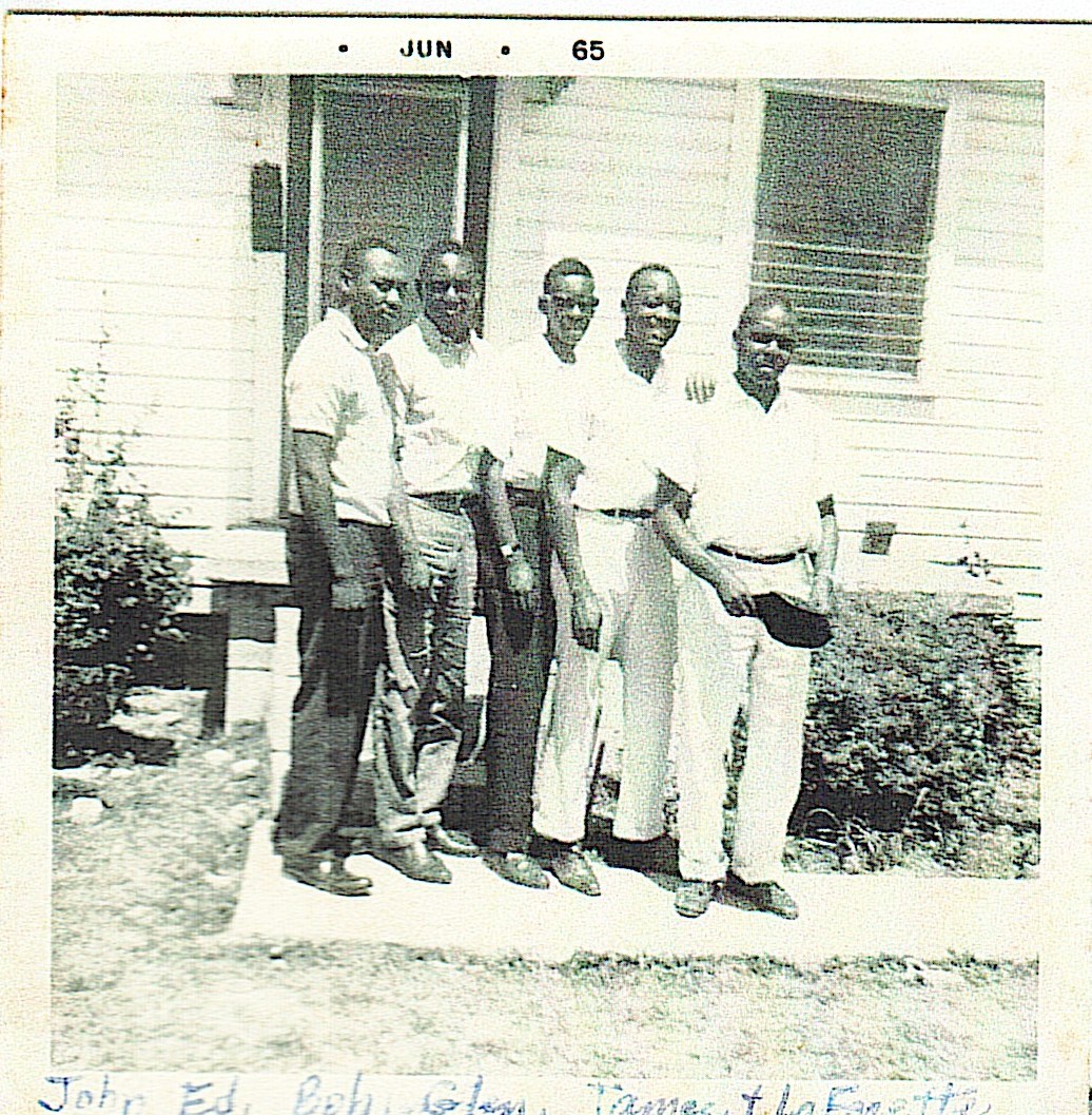 Historical family photograph of a group of men outside a home